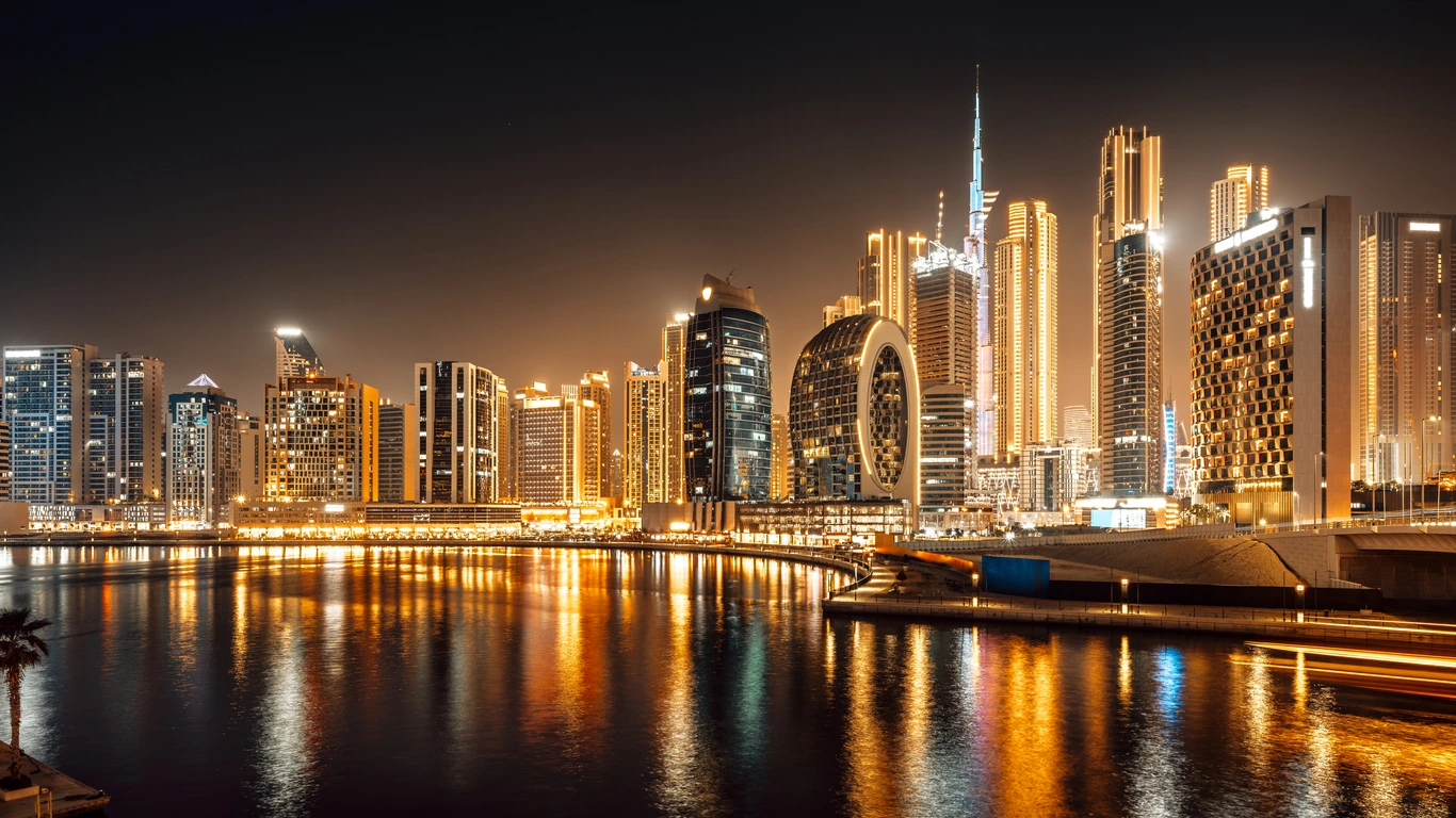 Business Bay towers and the Burj Khalifa at night, Dubai, UAE